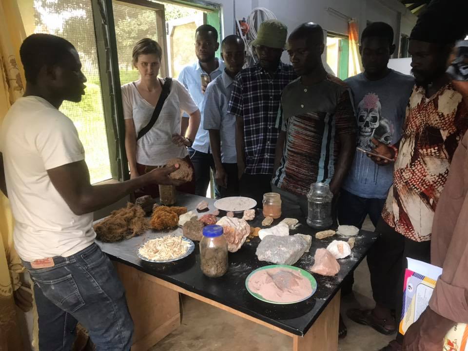 Man teaching group with various samples of different sustainable materials