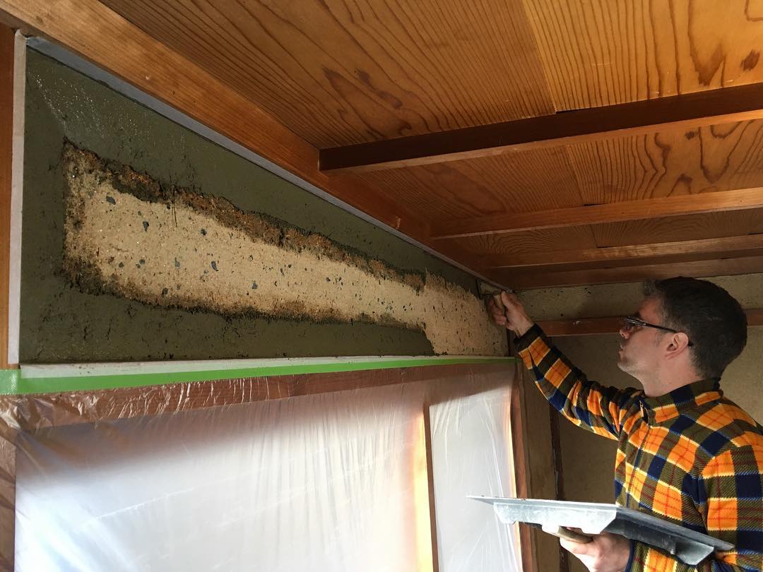 Student plastering a wall