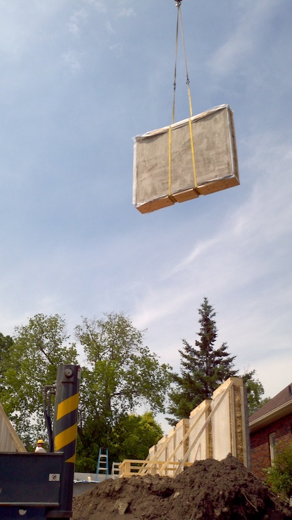 prefab straw bale wall panel craned into place
